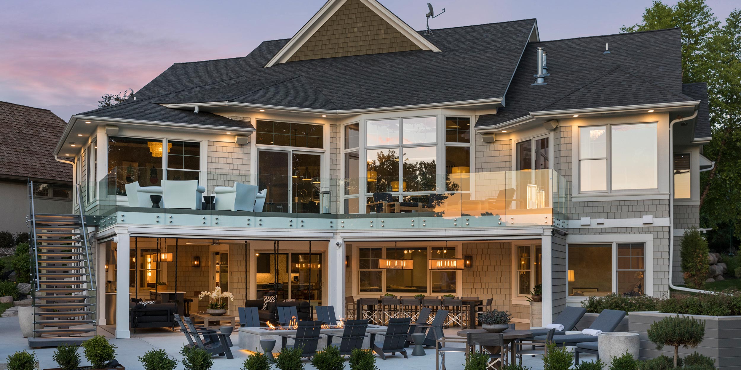 A modern indoor dining space with high ceilings and large windows.