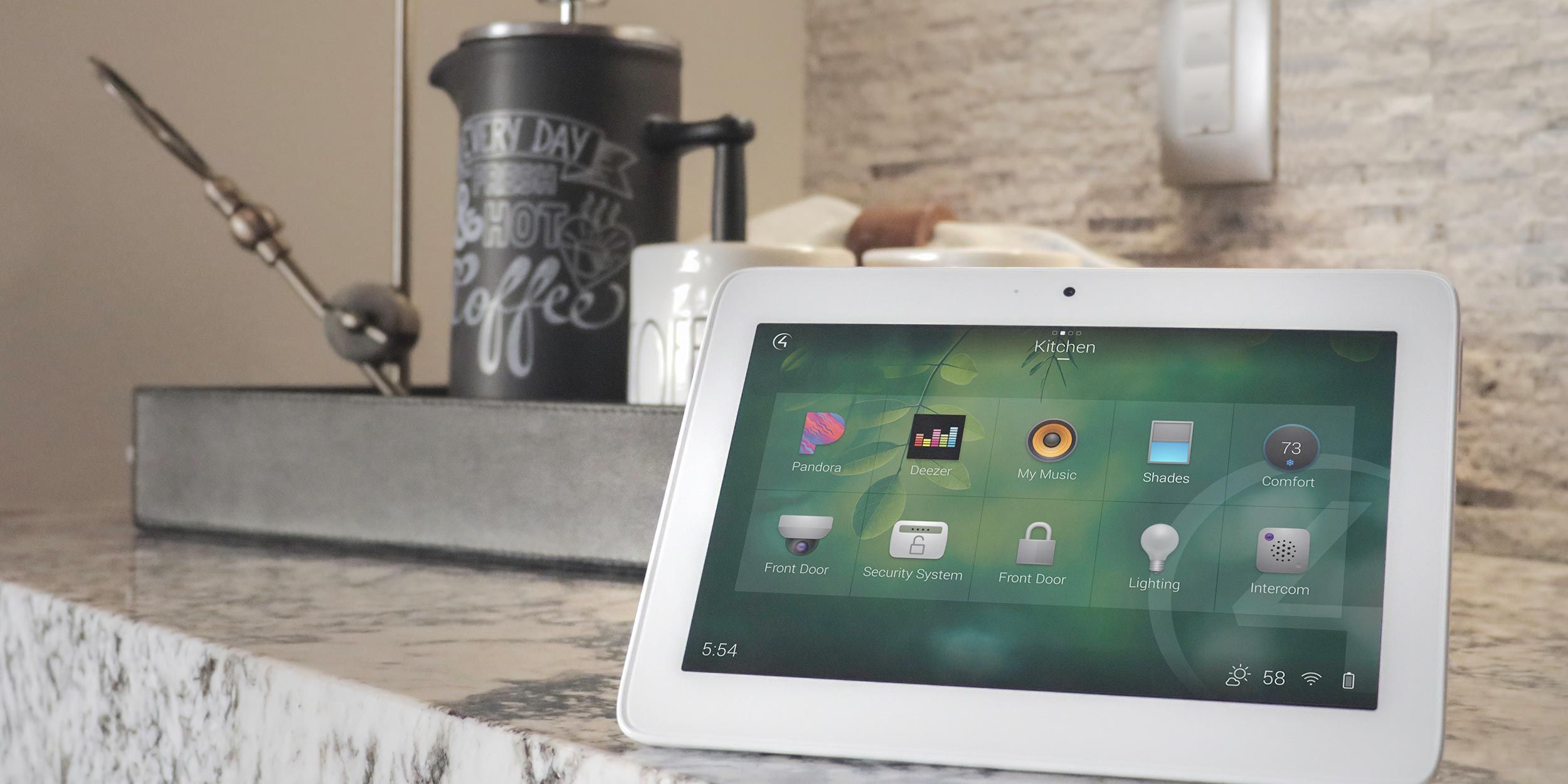 A smart home control tablet on a kitchen counter displaying automation options.